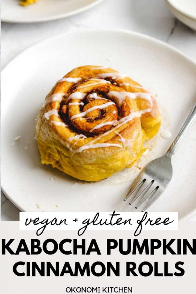 vegan gluten free pumpkin cinnamon roll with glaze on top on a white plate and fork pinterest