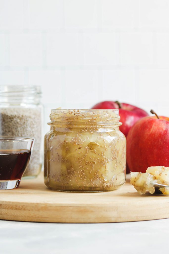 apple chia jam in a canning jar on a cheese board