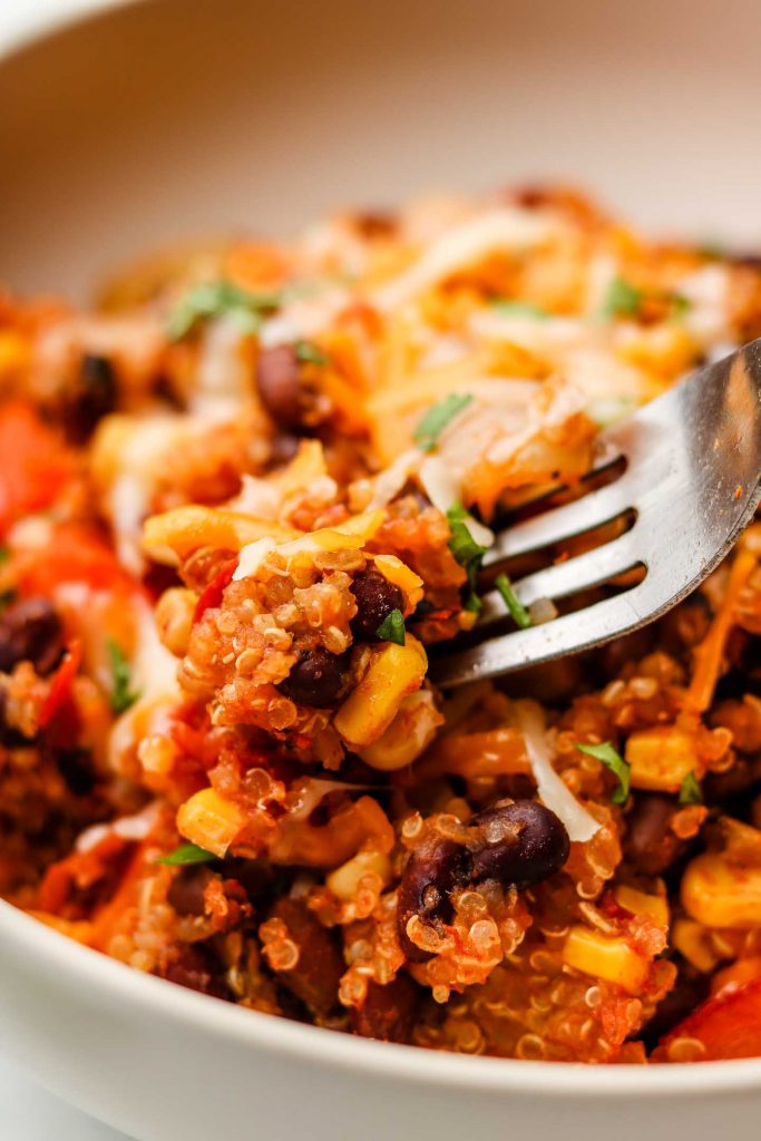 close up shot of quinoa taco rice in a bowl with a fork
