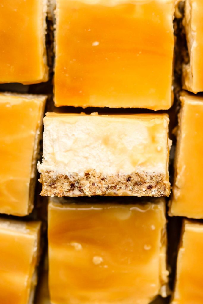 close up shot of no bake caramel cheesecake bars