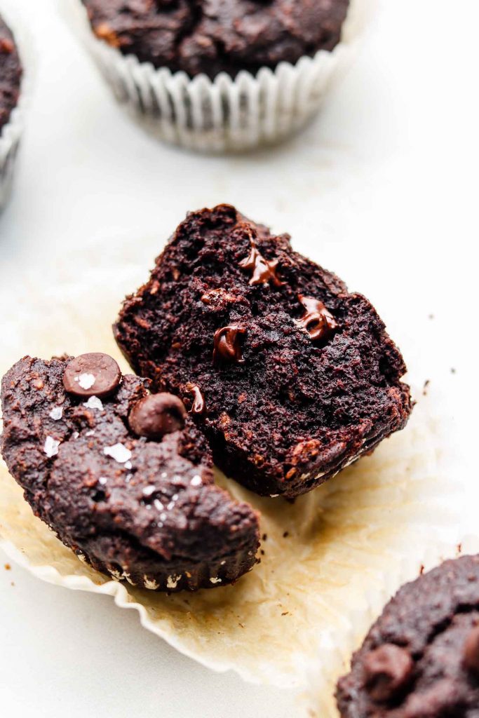 double chocolate vegan muffins split in half on a muffin liner