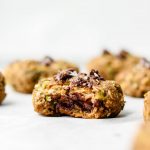 vegan zucchini chocolate chip oatmeal cookies with a bite taken out of the cookie