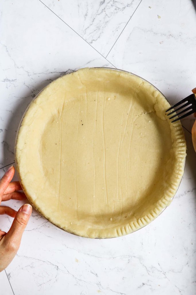 crimping healthy pie crust with a fork