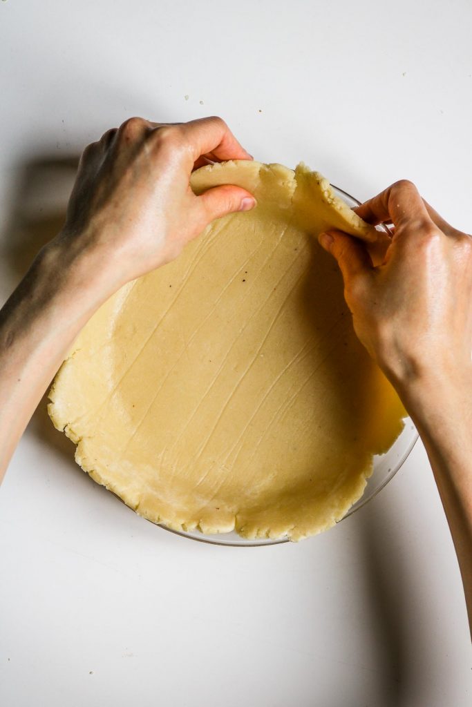 fixing pie crust edges with hands