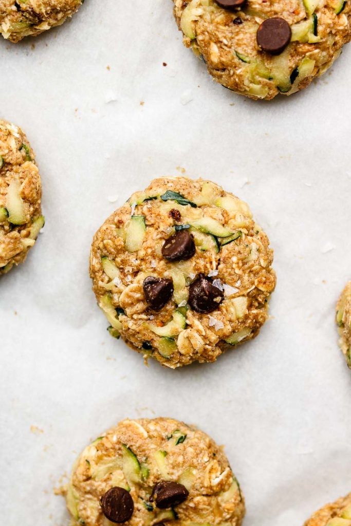 healthy zucchini cookies with chocolate chips before baking on parchment papaer