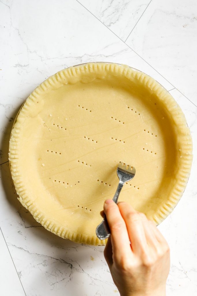 poking healthy pie crust with a fork