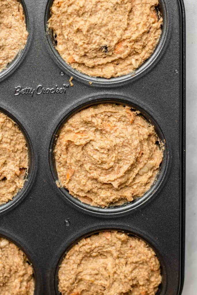 carrot apple muffin batter in a 6 cup muffin tin 