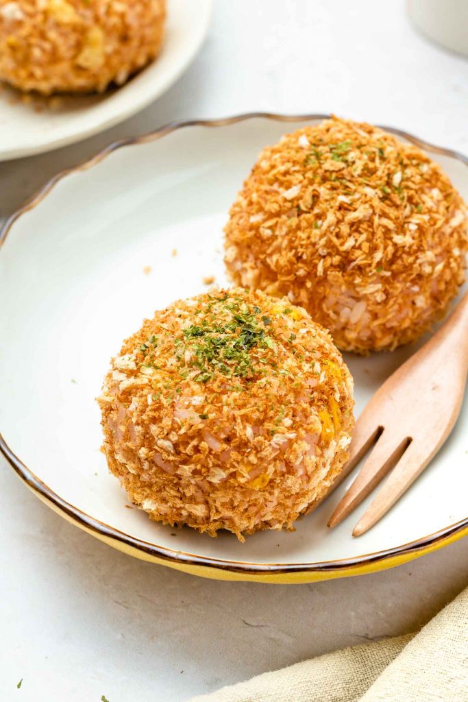 rice croquette on a white plate with parsley on top