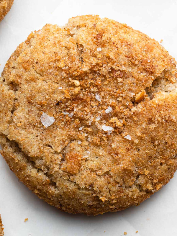 butter toast snickerdoodle cookie on parchment paper with cinnamon sugar bread crumbs