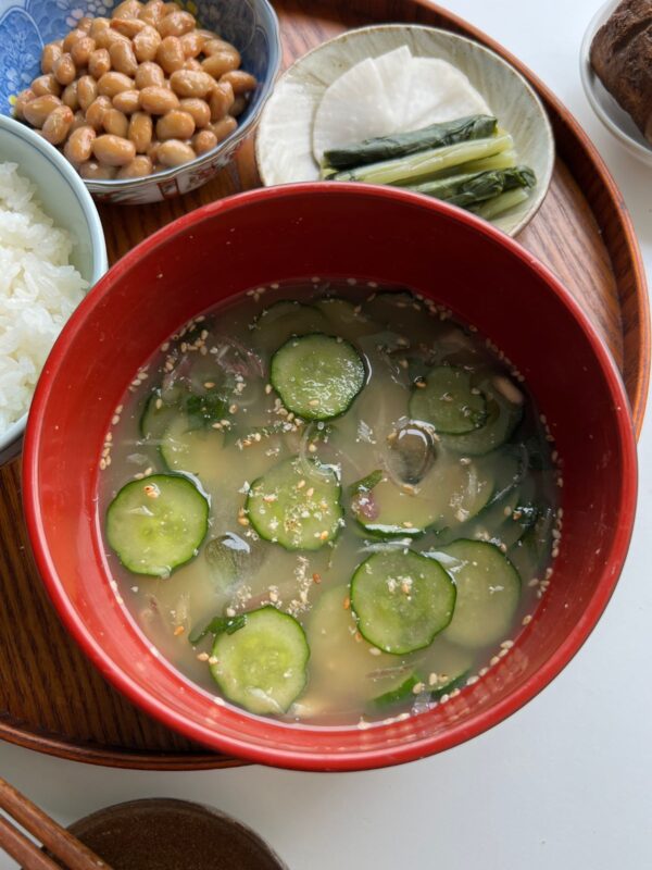 cucumber miso soup in a red bowl