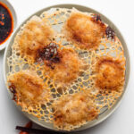 crispy rice paper dumplings with skirt on a wire rack and plate