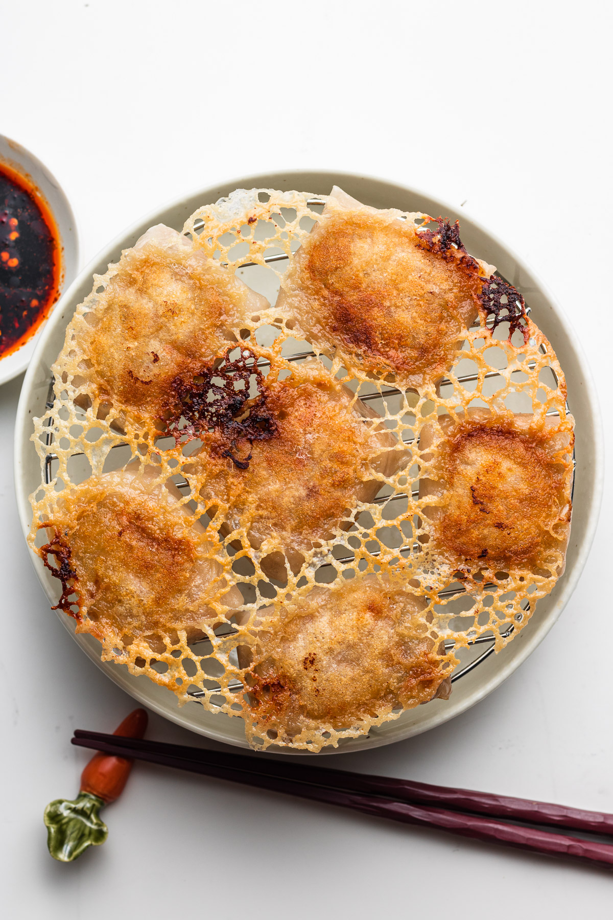 crispy rice paper dumplings with skirt on a wire rack and plate