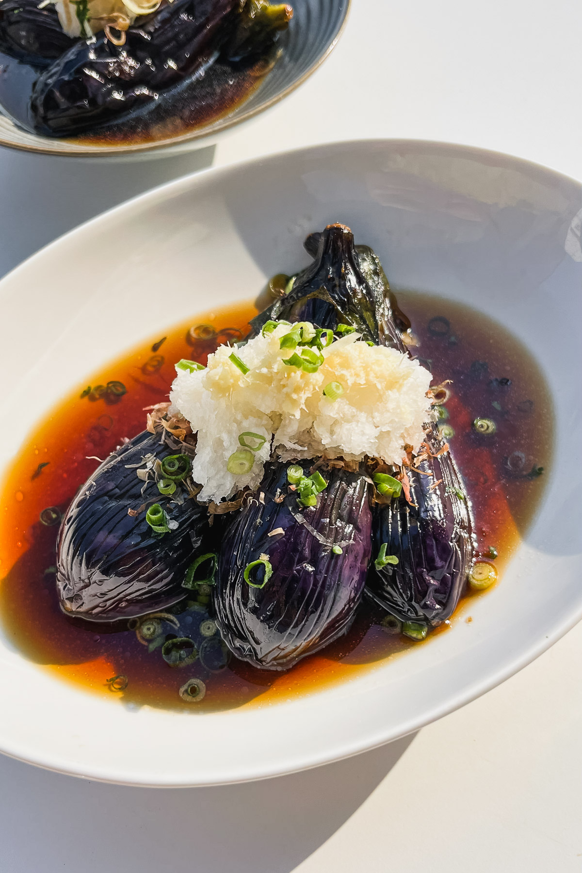 fried japanese eggplant in savory broth topped with daikon and ginger