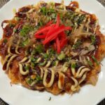 kimchi okonomiyaki on a white plate