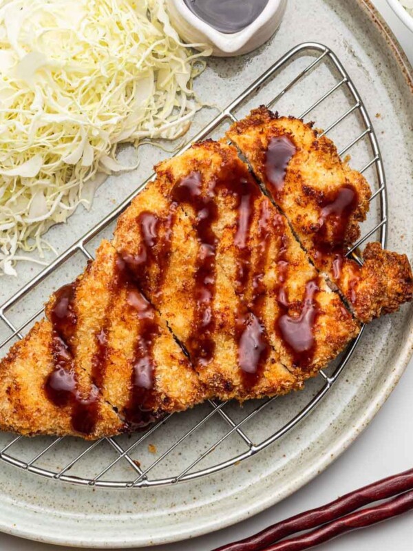 crispy air fried chicken katsu on a wire rack plate with tonkatsu sauce